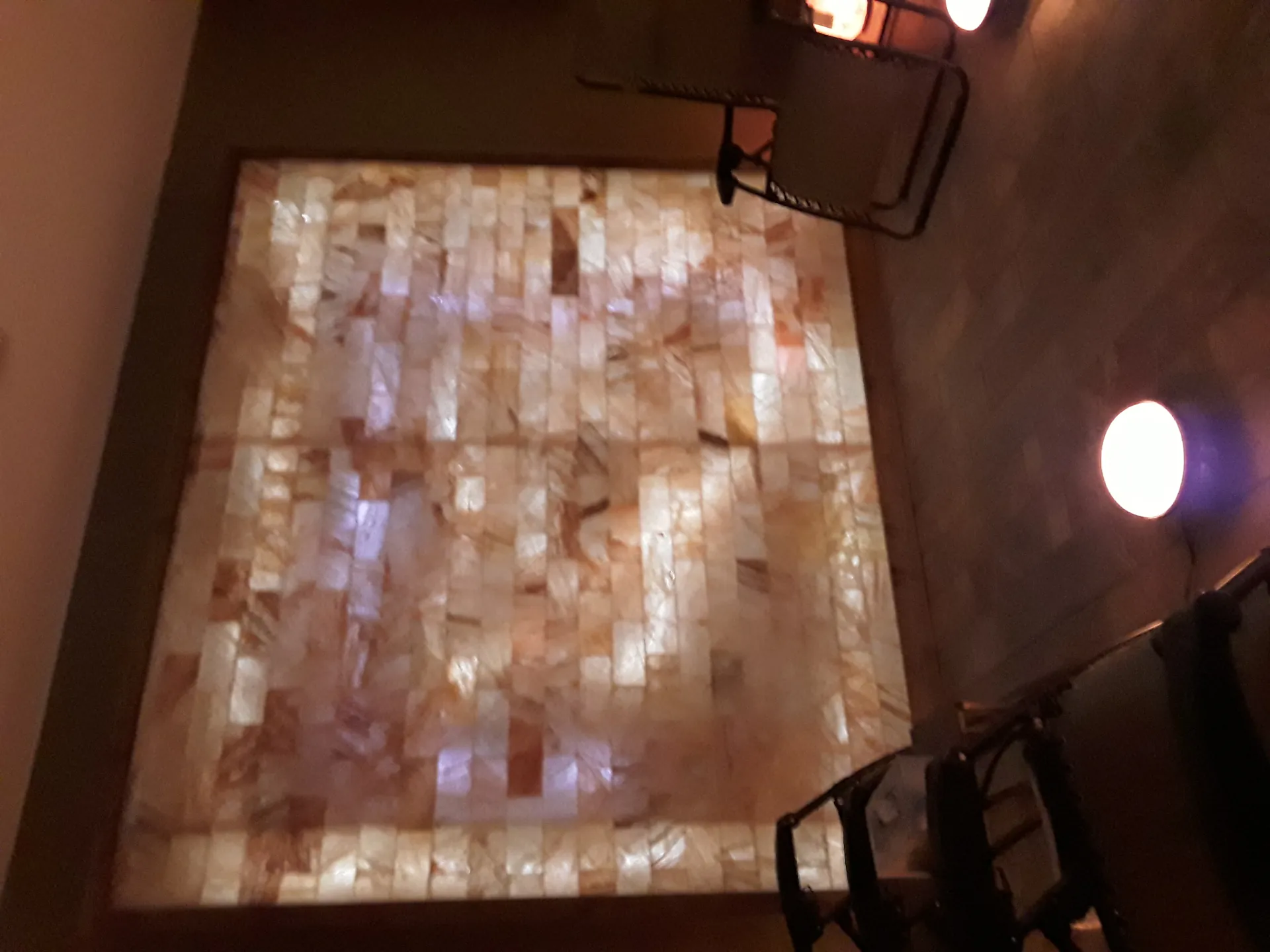 Salt therapy room interior with Himalayan salt wall, zero-gravity chairs, and ambient lighting